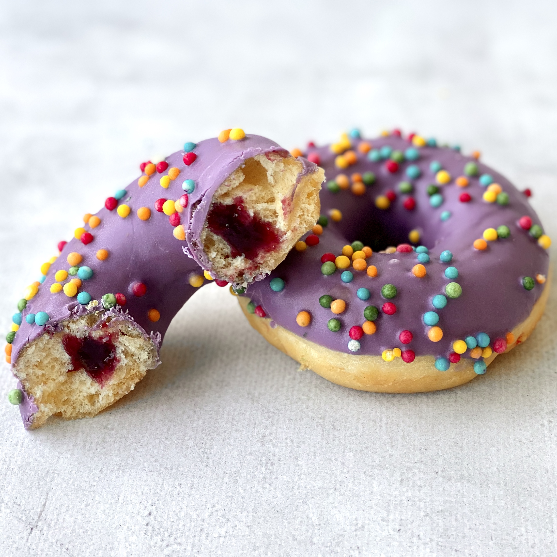 Пончик с черничной начинкой в цветной глазури и хрустящими шариками изображение 3
