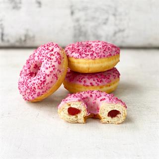 Пончик-донатс с малиновой начинкой, кондитерской розовой глазурью с розовой посыпкой